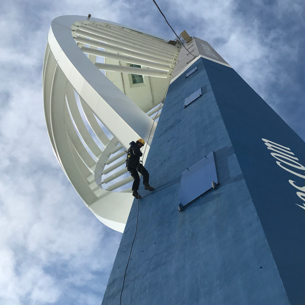 man-abseiling-down-spinnakker-tower